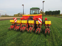 A precision seed drill at work in a clover living mulch.